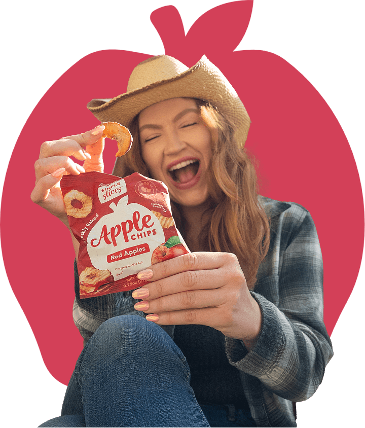 Woman in hat enjoying Simple Slices Red Apple Chips
